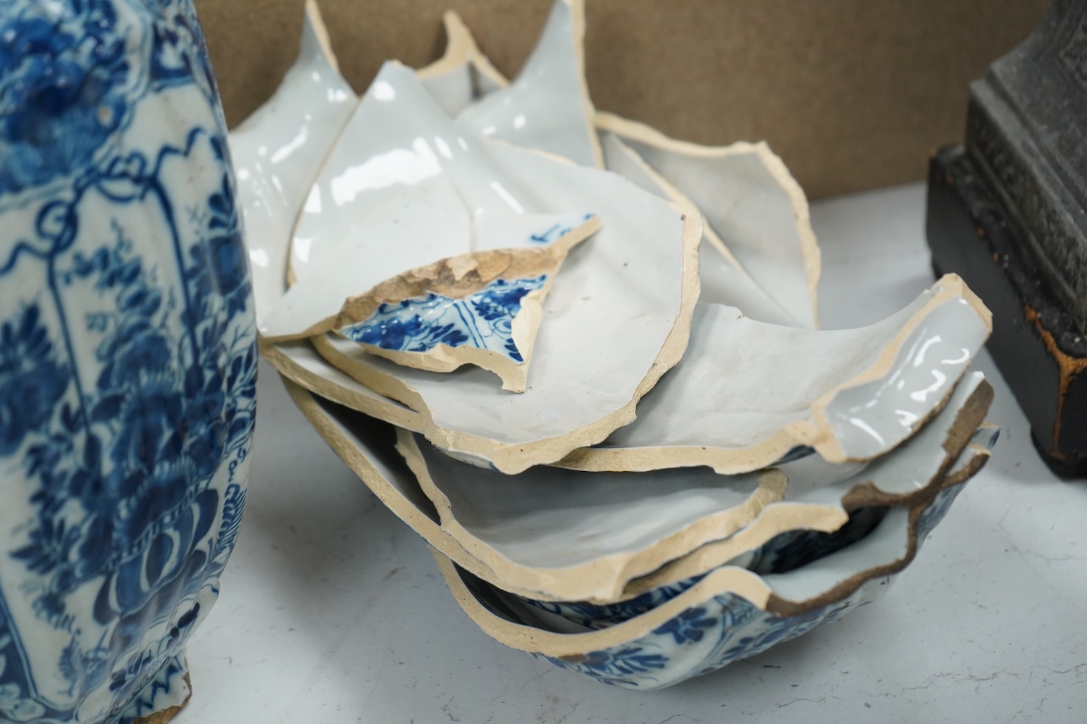 A late 17th century Delft faceted blue and white vase, by Lambartus van Eenhorn, and another broken similar, 29cm high (a.f.)